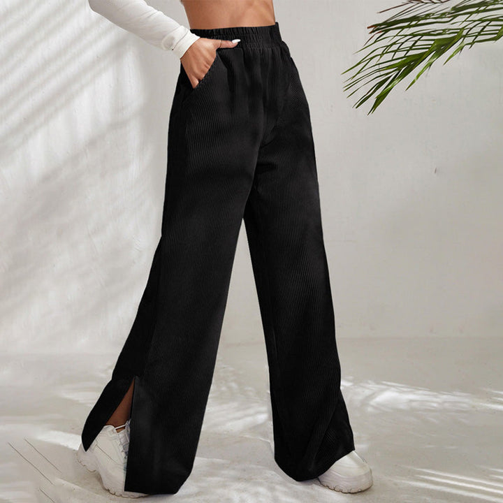 Woman wearing wide-leg ribbed joggers with a fitted top, relaxed at home.