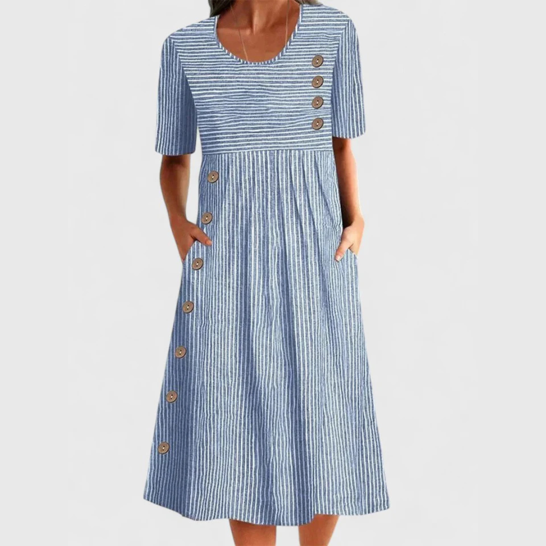 A woman wearing the Helen striped midi dress with button details, standing outdoors on a bright day.