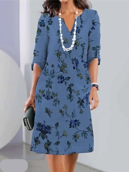 Woman wearing the Carolyn floral A-line dress in ivory, dressed for a daytime lunch.