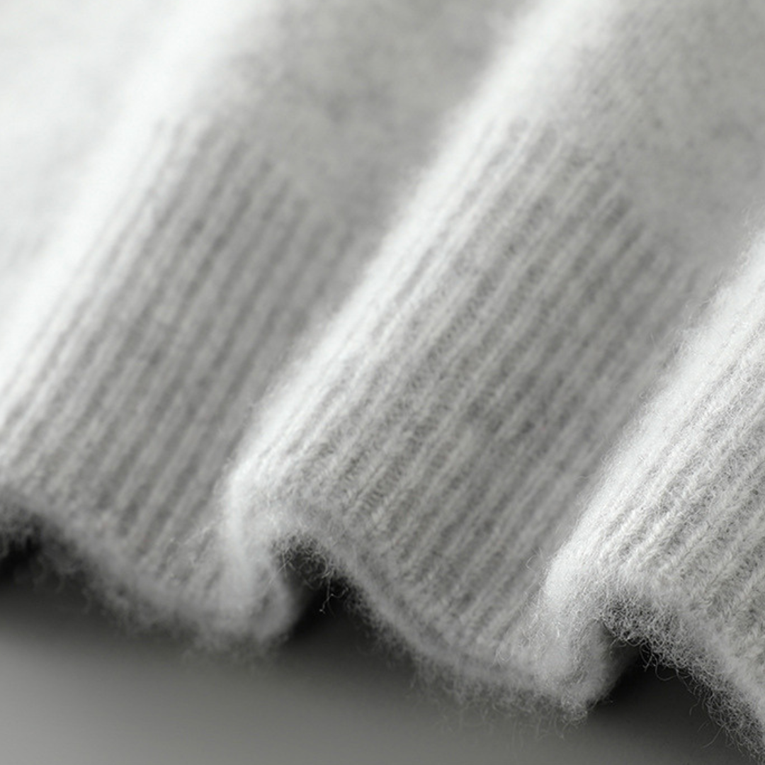 A woman wearing a soft luxe crew neck sweater with a matte finish, styled with smart pants.