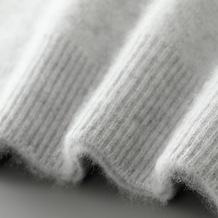 A woman wearing a soft luxe crew neck sweater with a matte finish, styled with smart pants.