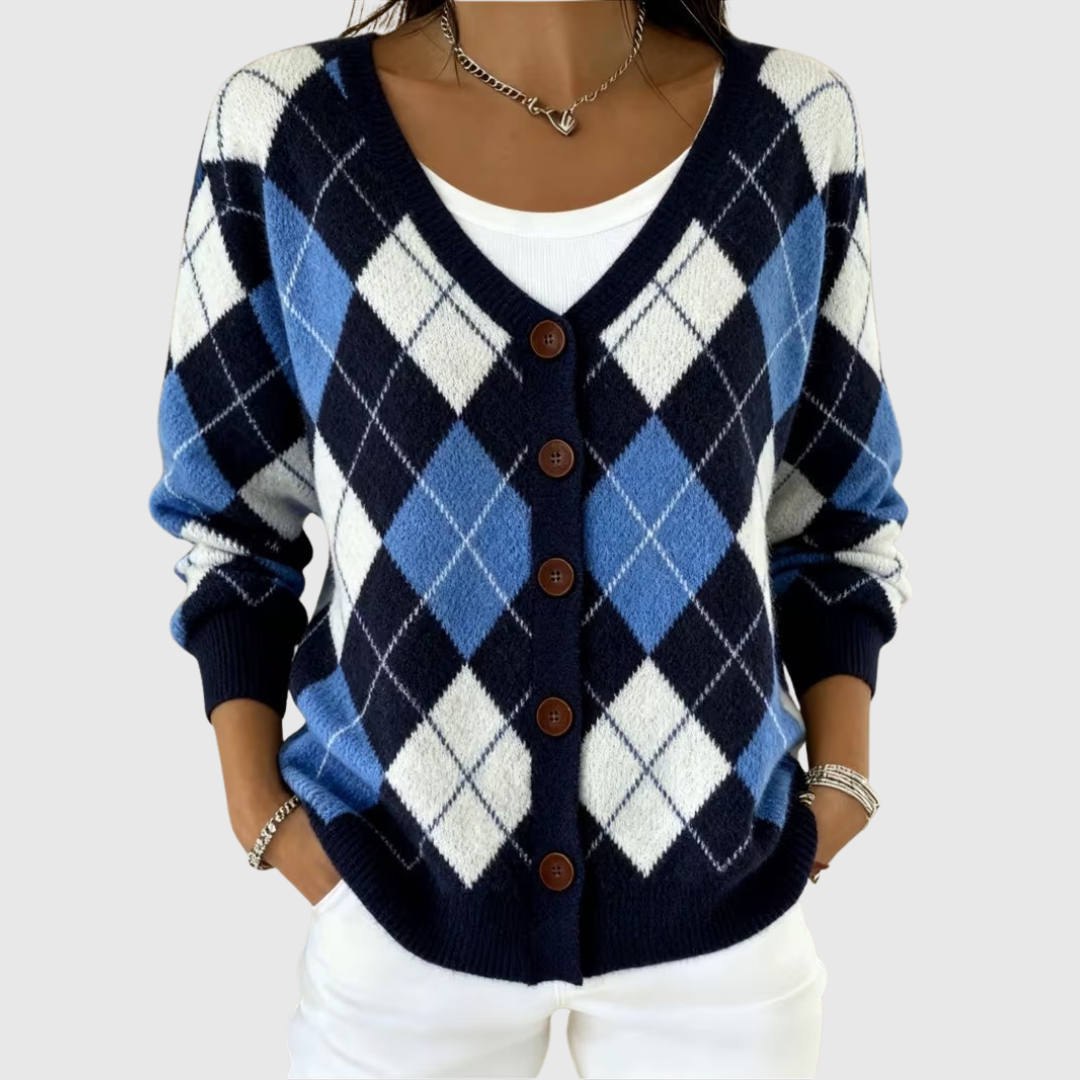 A woman wearing a navy and blue argyle button cardigan over a white top.