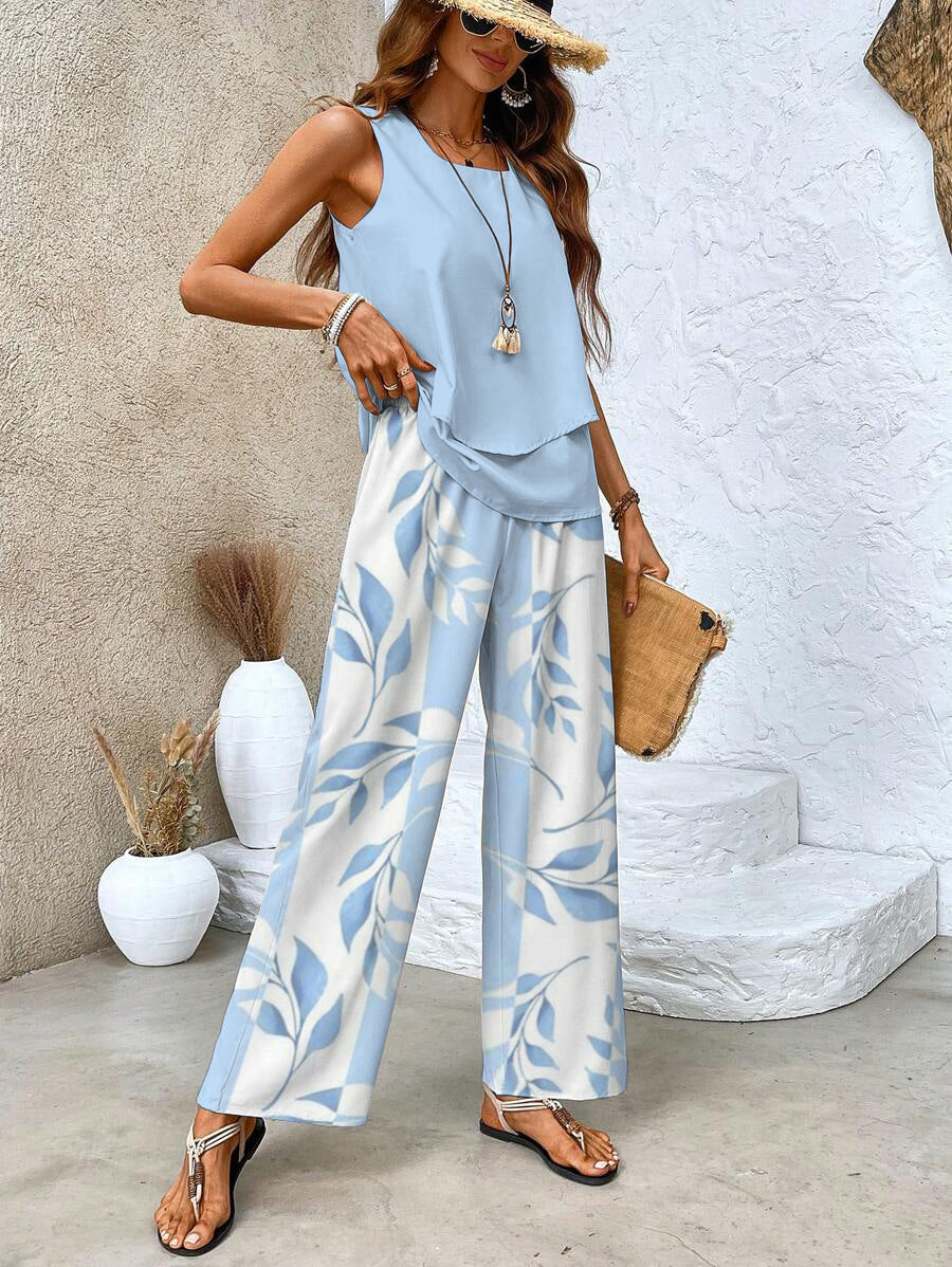 A woman wearing a layered sleeveless top with leaf-print wide-leg pants, light and elegant.