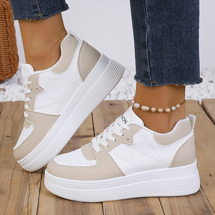 A woman wearing elegant two-tone platform sneakers in the city