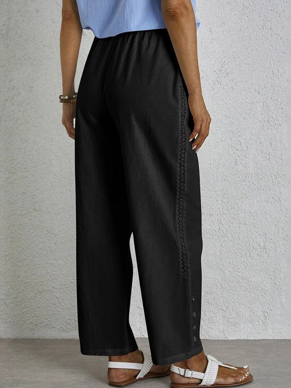 Woman wearing relaxed button-detail pants with a simple top, out for the day.