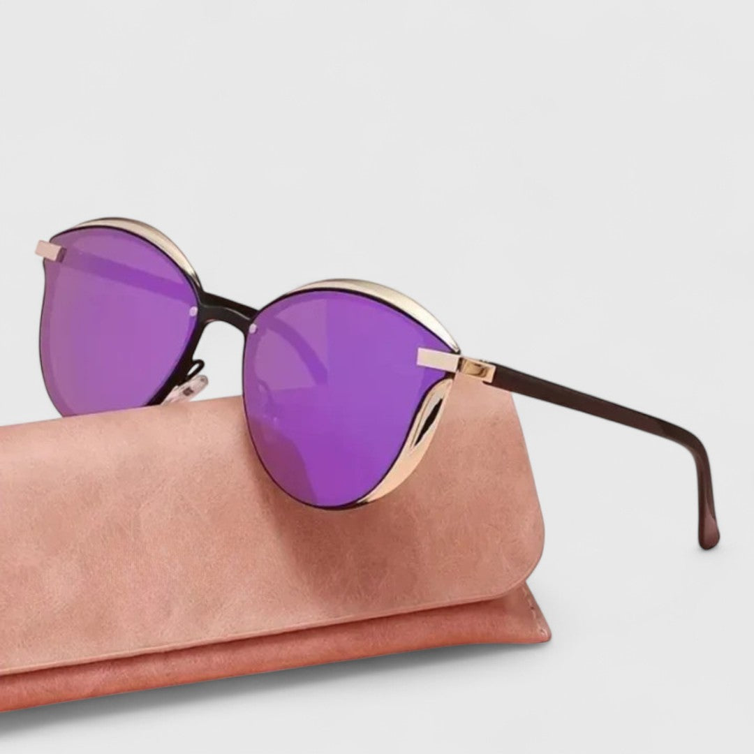 A woman wearing minimalist polarised gradient sunglasses on a bright day.