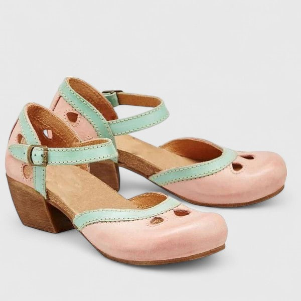 A woman in blue and green retro block heel shoes at a summer garden party.