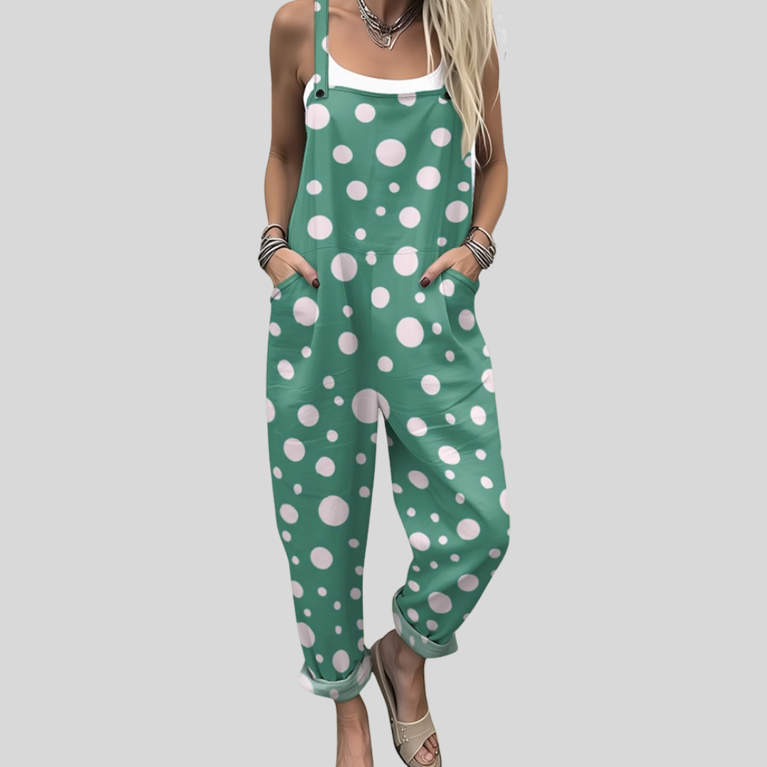 A woman wearing fresh green overalls covered in white polka dots, with adjustable straps.