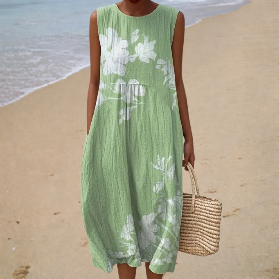 A woman wearing a sleeveless printed summer dress, light and easy on a warm day.
