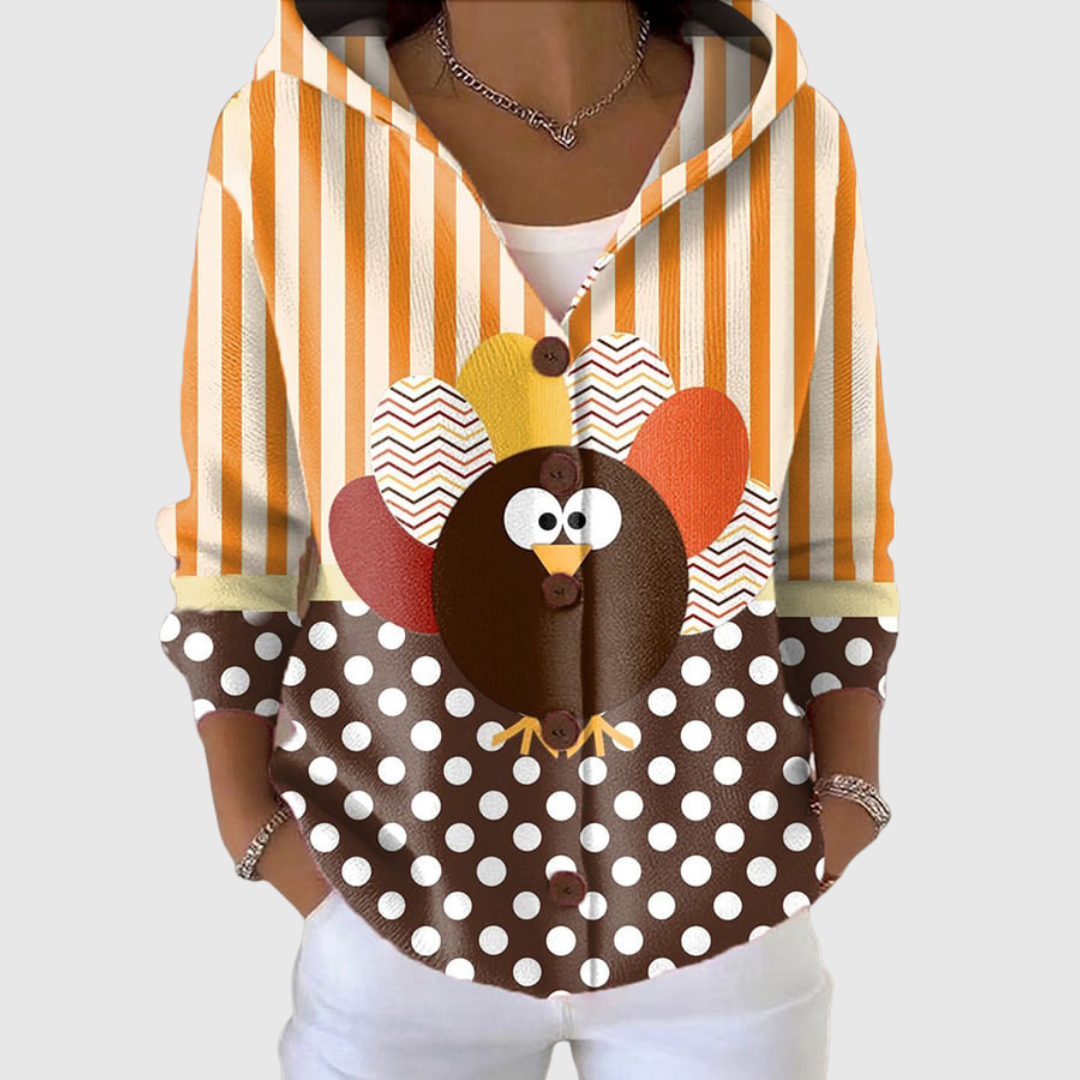 A woman wearing a soft hooded cardigan, warm and relaxed on a mild day