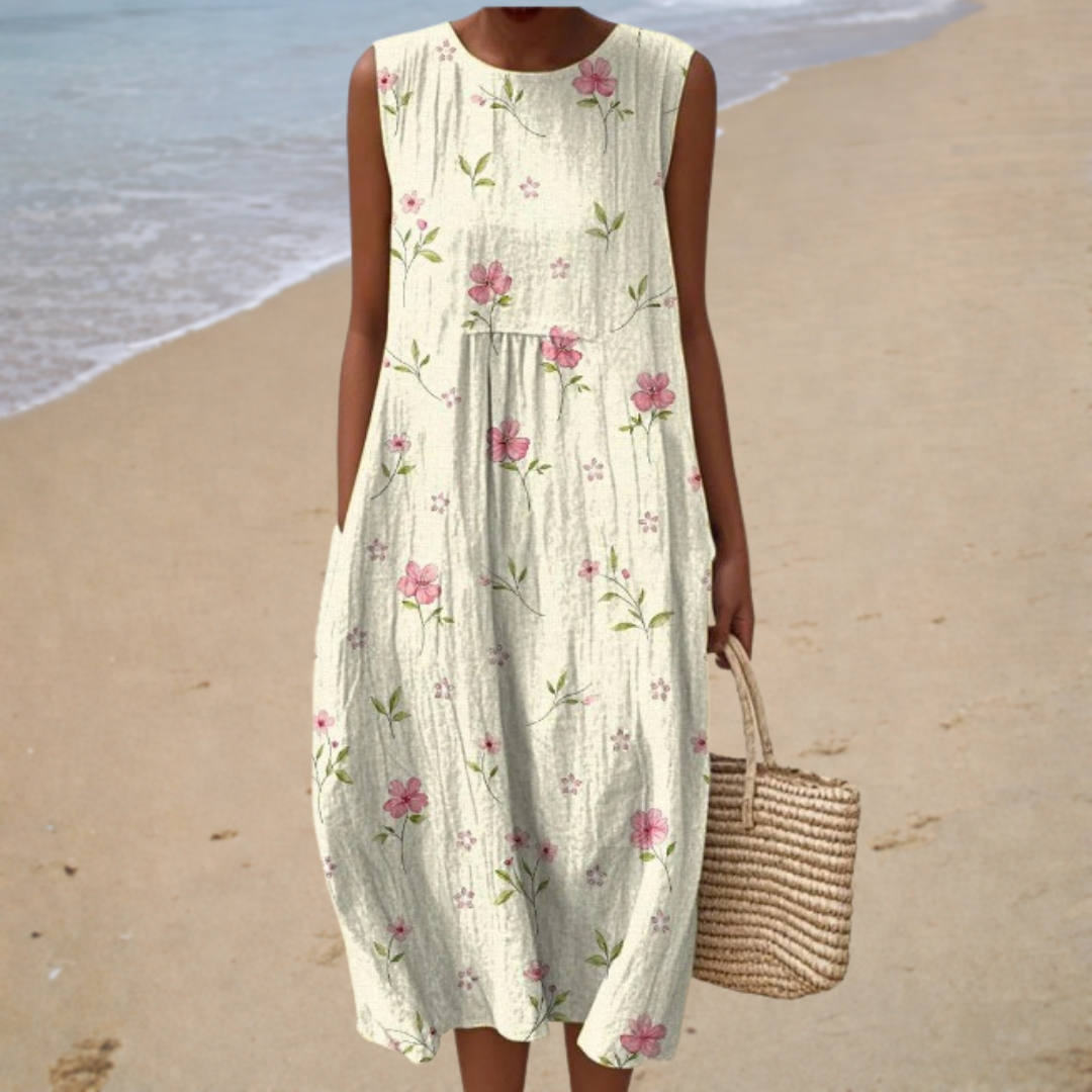 A woman in a light sleeveless summer dress with an elegant pattern, enjoying a bright summer afternoon.