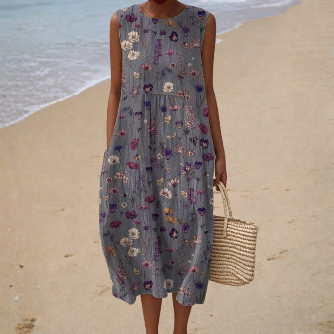 A woman wearing a sleeveless printed summer dress, cool and elegant on a hot day.
