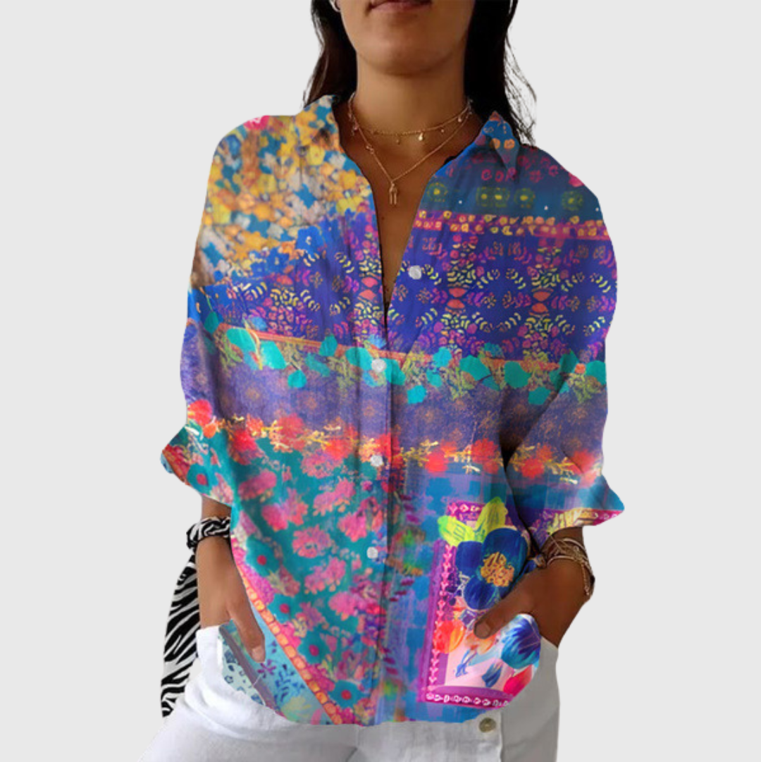 A woman wearing a relaxed colourful printed blouse with an elegant button front, comfortable and bright on a day out.
