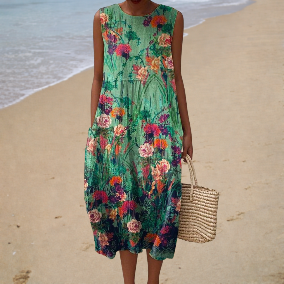 A woman wearing a loose sleeveless printed summer dress, standing relaxed on a warm sunny day.