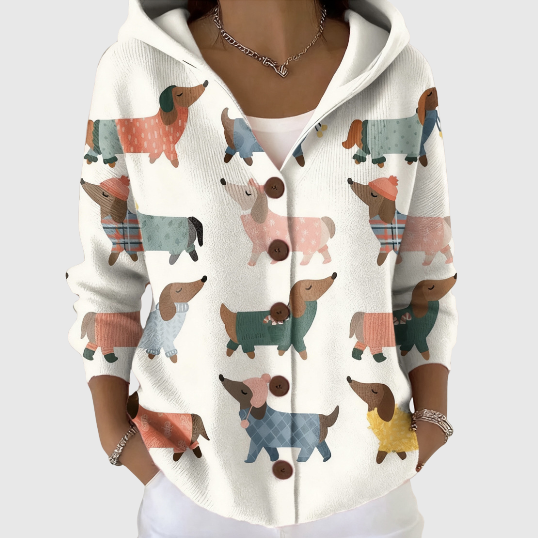 A woman wearing a cosy hooded cardigan, warm and relaxed on a cool day