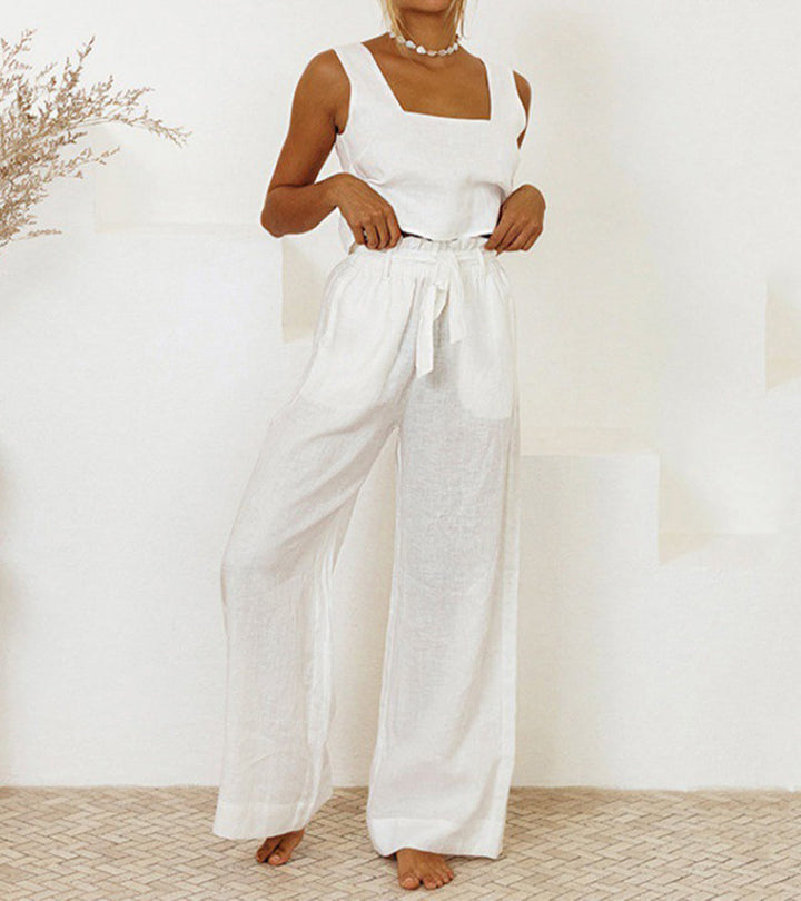 A woman wearing a minimal two-piece set with a square neckline and belted flared pants.