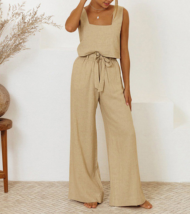 A woman wearing a minimal two-piece set with a square neckline and belted flared pants.