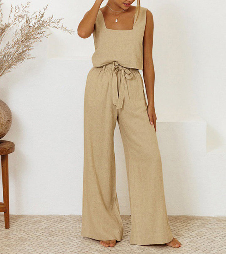 A woman wearing a minimal two-piece set with a square neckline and belted flared pants.