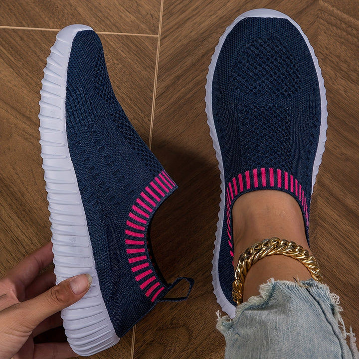 A woman slipping on ultralight sock-style sneakers that hug the foot.