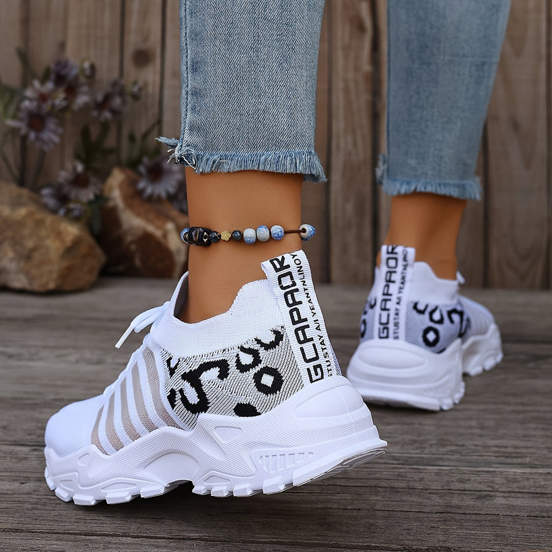 A woman walking in light, breathable comfort sneakers on a warm day.