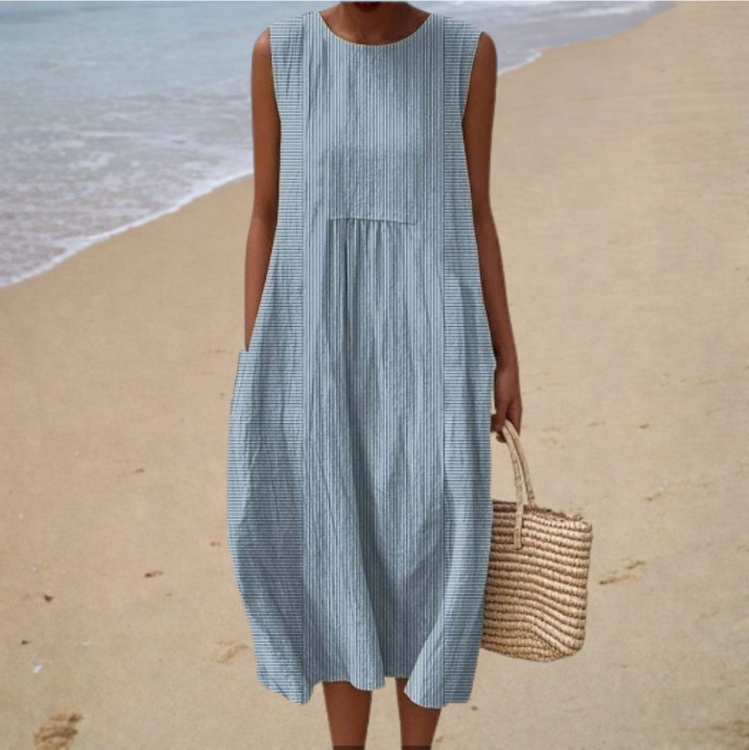 A woman wearing a relaxed sleeveless summer dress, cool and comfortable in the afternoon sun.