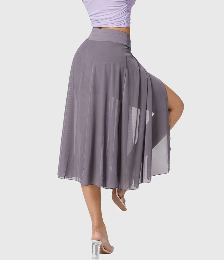 A woman in an elegant high-waisted flowing skirt, styled for a versatile day-to-evening look.