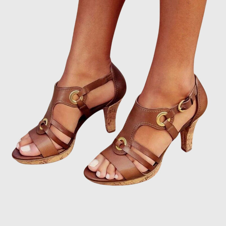 A woman in supportive heeled sandals standing comfortably at a summer event.