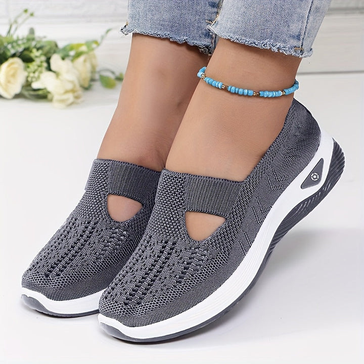 A woman stepping into easy slip-on comfort sneakers with no laces.