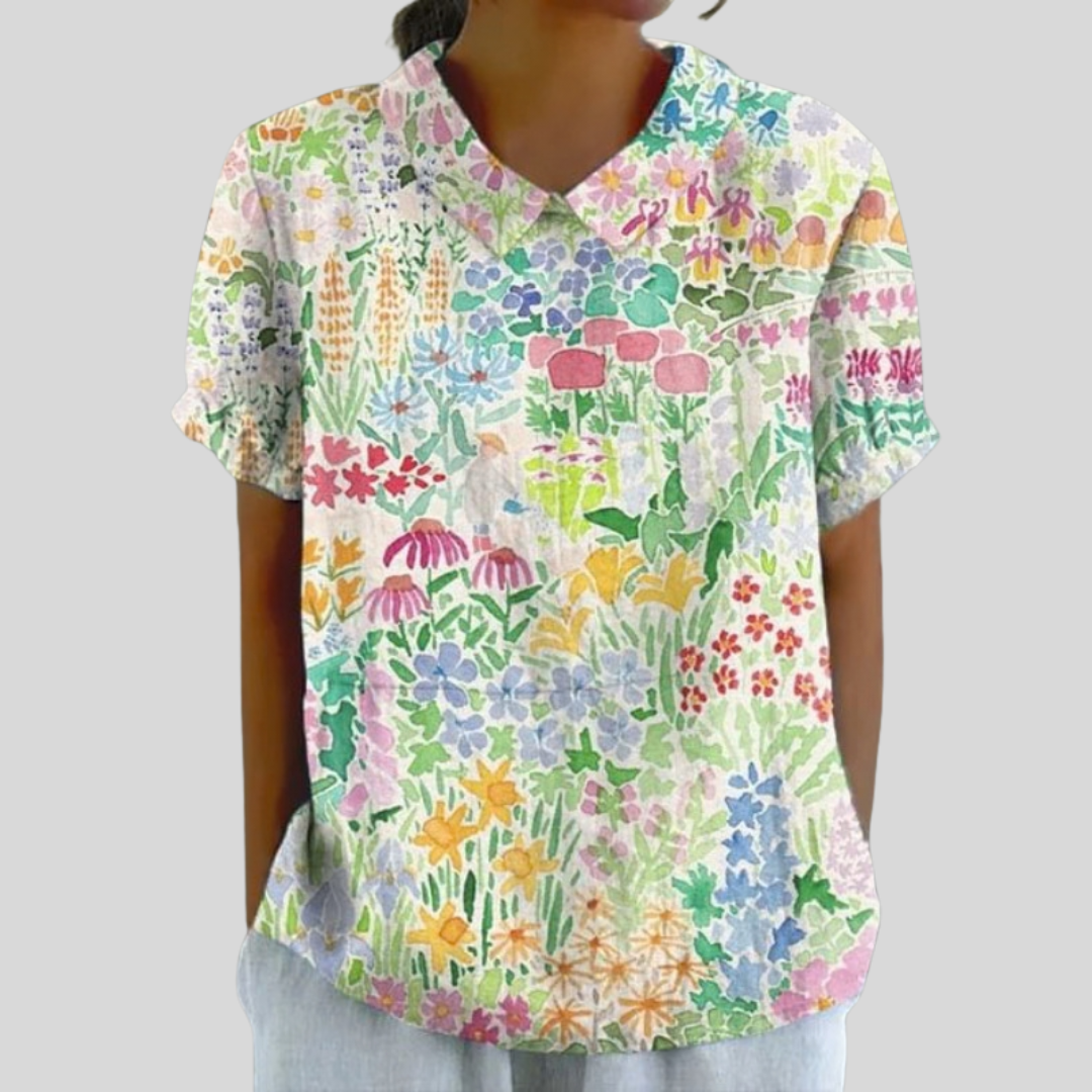 A woman wearing a flattering floral top with a polo collar, looking feminine and confident.