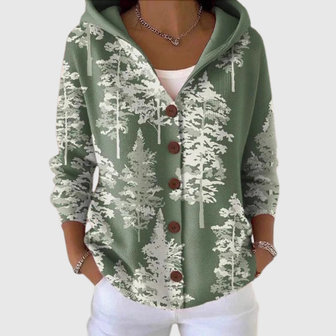 A woman wearing a soft hooded cardigan open over a top, relaxed on a mild day
