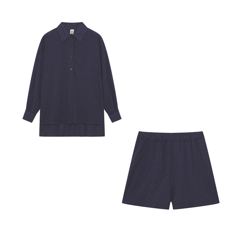 A woman wearing a classic button shirt with matching relaxed shorts, polished and easy.