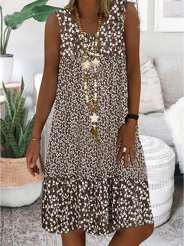 A woman wearing the Wendy sleeveless V-neck floral dress on a sunny day outdoors.