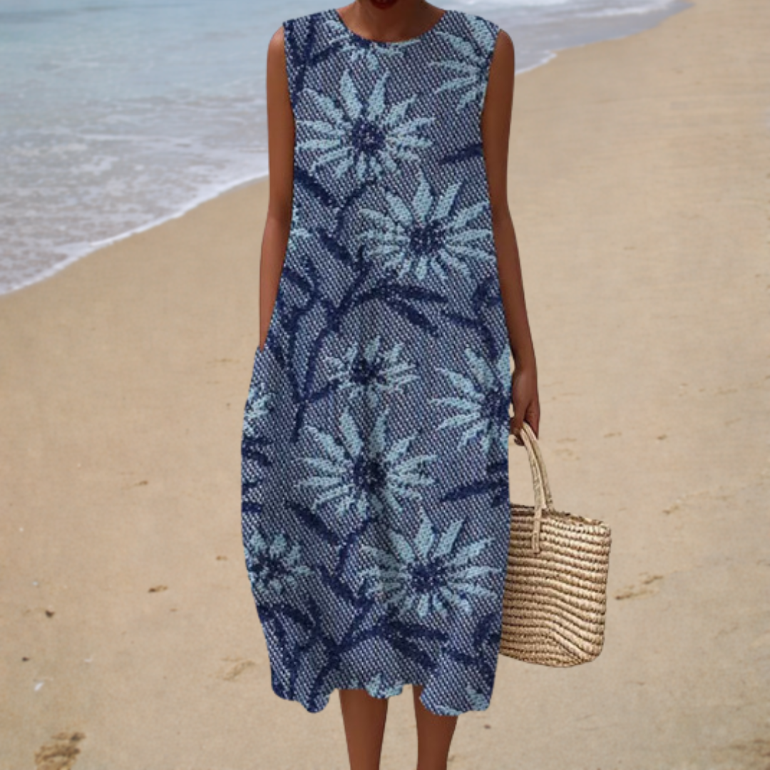 A woman wearing a loose sleeveless patterned summer dress, cool and elegant on a warm day.