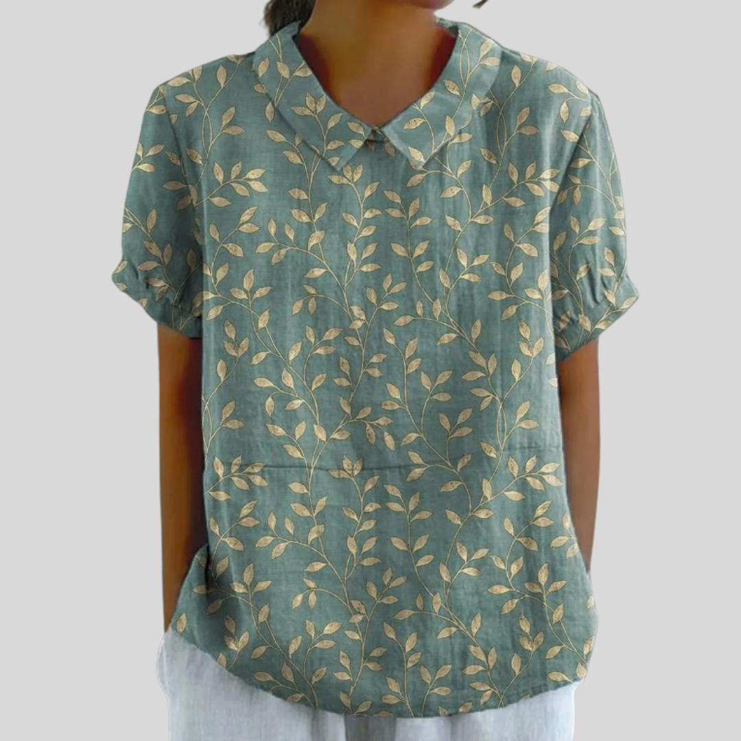A woman wearing a soft green leaf print top with a polo collar on an easy day out