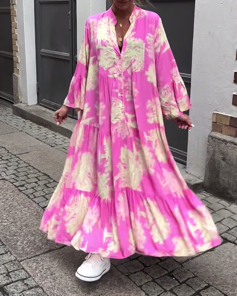 Woman wearing the Sylvie flowing maxi dress with a delicate print and V-neckline, the skirt moving softly as she walks.