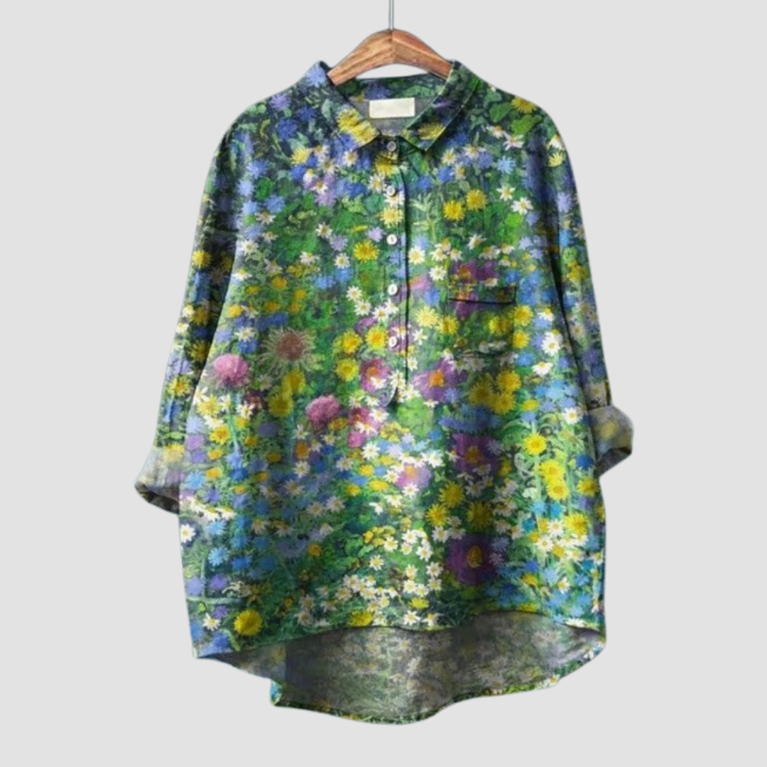 A woman wearing an elegant patterned summer blouse, looking polished from day into evening.