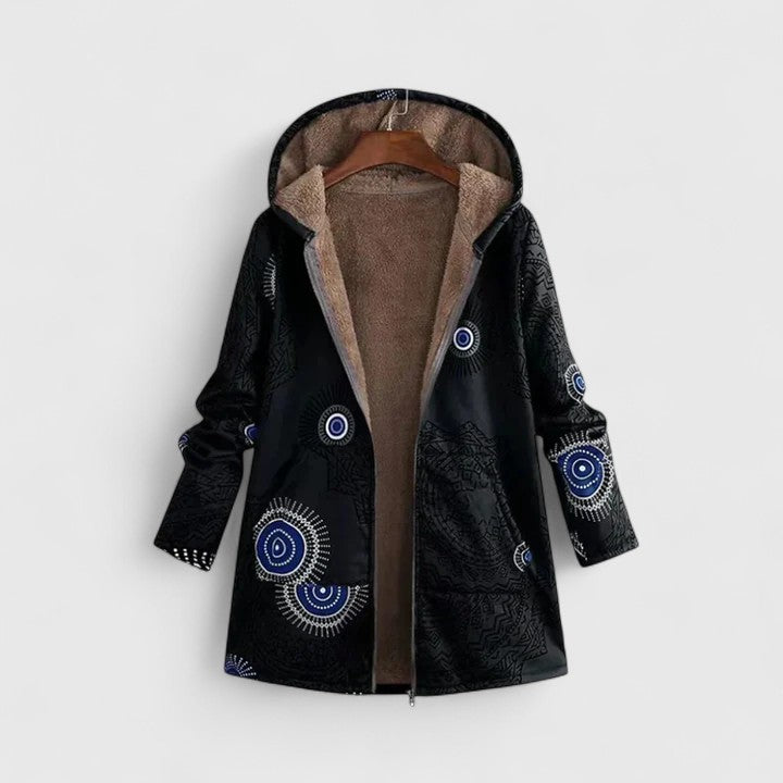A woman wearing a geometric-print boho jacket, warmly layered on a winter day out.