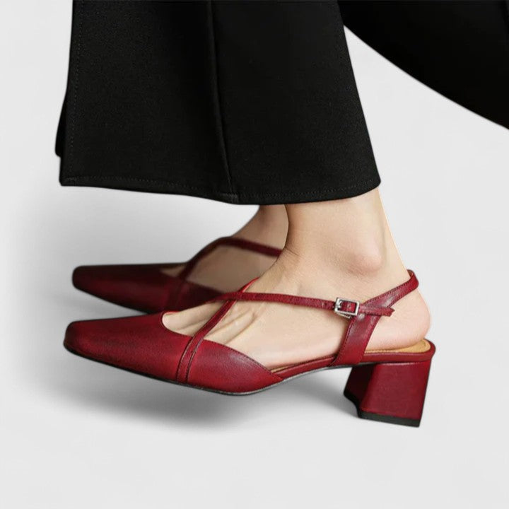 Burgundy closed square-toe flats with criss-cross instep straps and a buckled slingback.