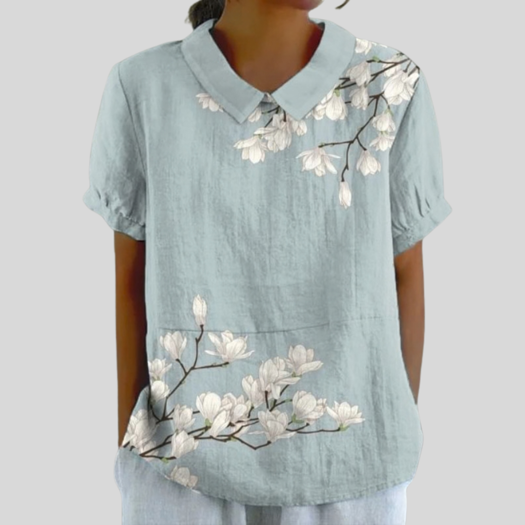 A woman wearing a floral top with a polo collar on a relaxed day out