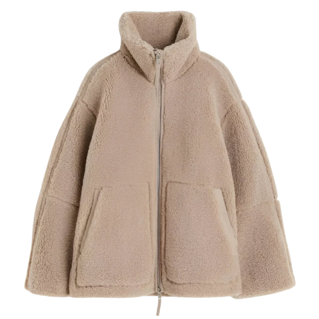 A soft, textured winter jacket with a tall stand collar, zip front and patch pockets