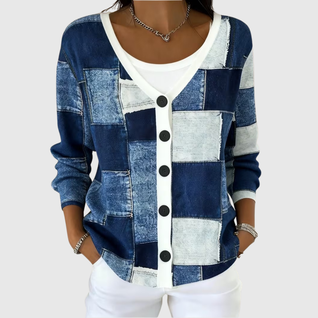A woman wearing a blue patchwork print button cardigan over a white top.