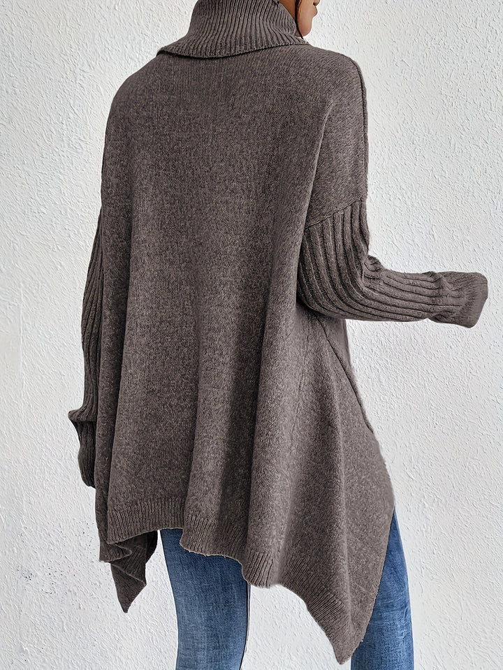 A woman wearing a stand-collar sweater with a chic asymmetric drape, warm and polished.
