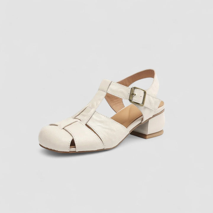 A woman in burgundy closed-toe woven sandals with a low block heel, comfortable browsing a market.
