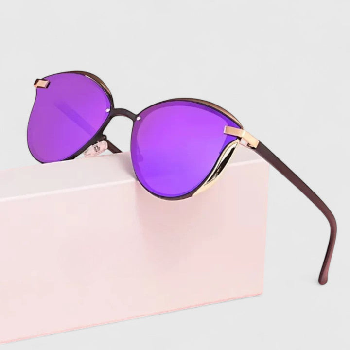 A woman wearing minimalist polarised gradient sunglasses on a bright day.
