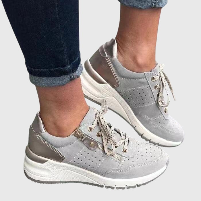 A woman on a walk wearing soft, supportive sneakers on a bright day.