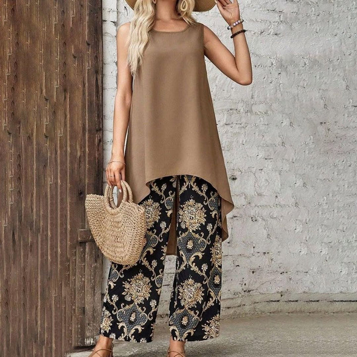 A woman wearing a flowing boho tunic with printed wide-leg pants, relaxed and artful.