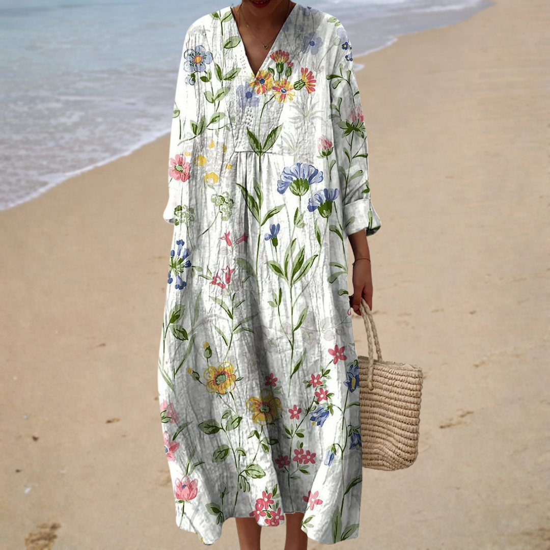 A woman wearing a floaty printed dress with a soft drape on a warm afternoon.