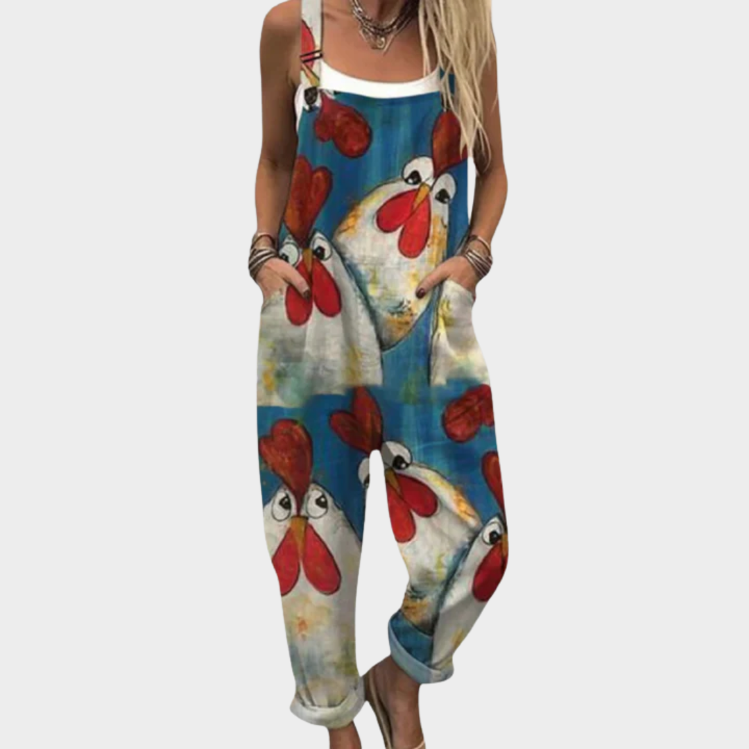 Woman wearing rich blue overalls printed with big cheerful hens with bright red combs