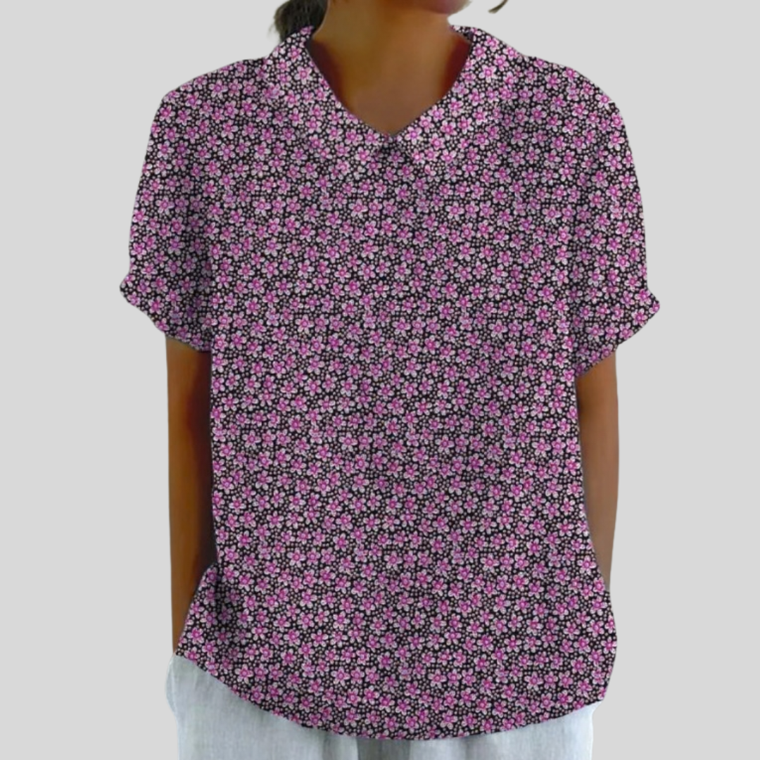 A woman wearing a soft floral top with a fine collar, confident and comfortable on a day out.
