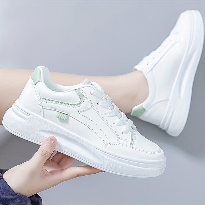 A woman in crisp white light comfort sneakers paired with jeans.